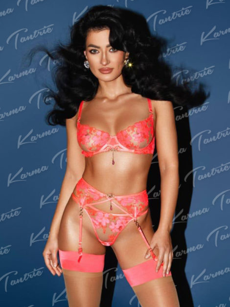 Alara standing in pink lingerie
